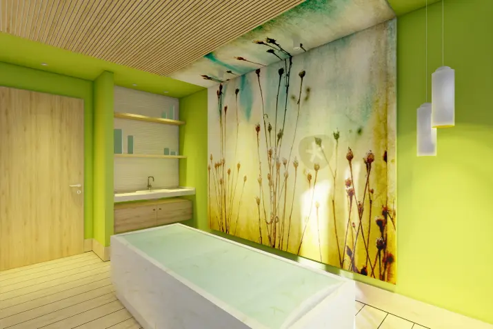 Ein Hamam mit einer weißen Badewanne in der Mitte, hellem Holzfußboden und einer lebendig grünen Akzentwand.